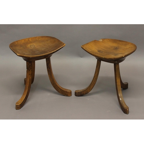 709 - PAIR OF LIBERTY THEBES STOOLS a pair of stools with dish shaped tops and supported on three splayed ... 