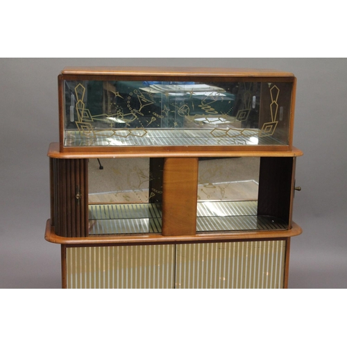 718 - RETRO COCKTAIL CABINET - 'RIVINGTON CABINET WORKS' a large walnut veneered cabinet, with glass slidi... 