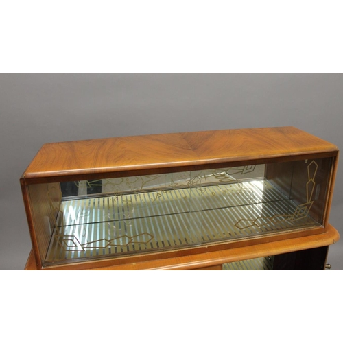 718 - RETRO COCKTAIL CABINET - 'RIVINGTON CABINET WORKS' a large walnut veneered cabinet, with glass slidi... 