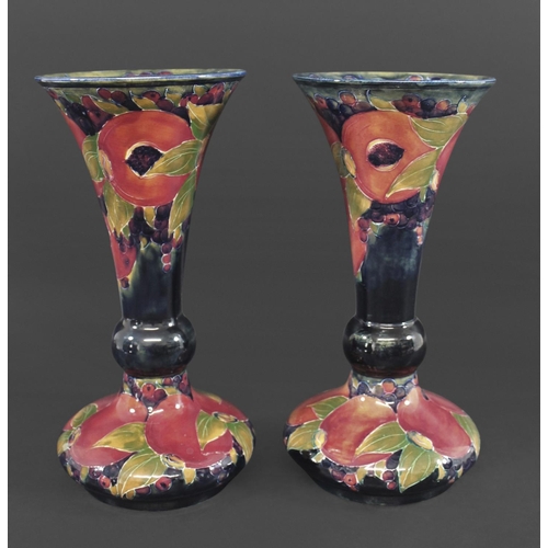 722 - PAIR OF WILLIAM MOORCROFT VASES - POMEGRANATE a large pair of vases with a trumpet shaped neck, in t... 