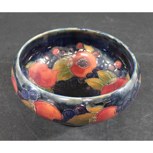 723 - WILLIAM MOORCROFT BOWL in the Pomegranate design on a blue ground. Painted signature and impressed m... 