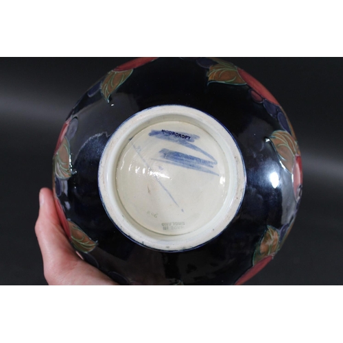 723 - WILLIAM MOORCROFT BOWL in the Pomegranate design on a blue ground. Painted signature and impressed m... 