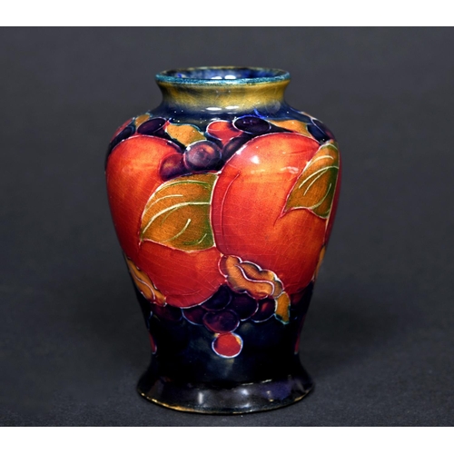 725 - MINIATURE MOORCROFT VASE - POMEGRANATE a miniature vase painted in the Pomegranate design on a blue ... 