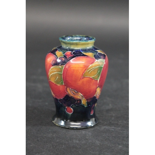 725 - MINIATURE MOORCROFT VASE - POMEGRANATE a miniature vase painted in the Pomegranate design on a blue ... 