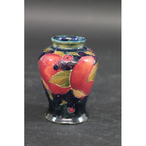 725 - MINIATURE MOORCROFT VASE - POMEGRANATE a miniature vase painted in the Pomegranate design on a blue ... 