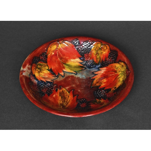 728 - MOORCROFT FLAMBE PLATE - LEAF & BERRY a plate painted in the leaf & berry design and with a flambe g... 