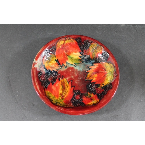 728 - MOORCROFT FLAMBE PLATE - LEAF & BERRY a plate painted in the leaf & berry design and with a flambe g... 