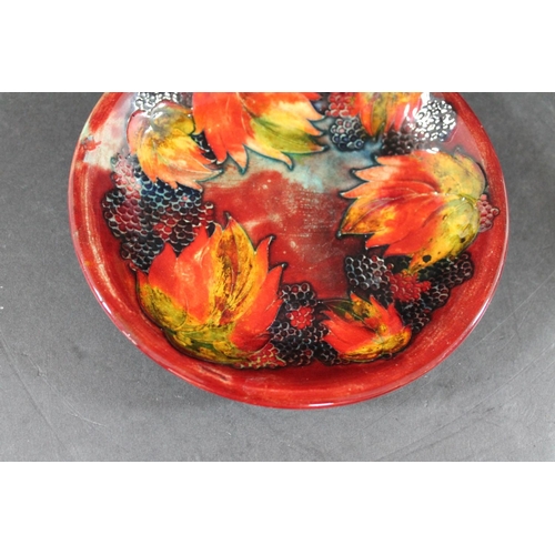 728 - MOORCROFT FLAMBE PLATE - LEAF & BERRY a plate painted in the leaf & berry design and with a flambe g... 