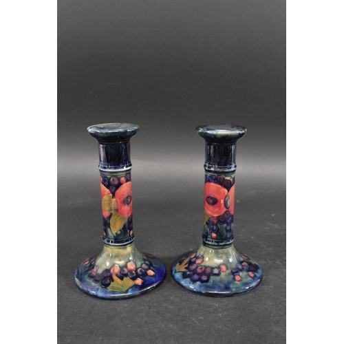 729 - PAIR OF MOORCROFT CANDLESTICKS - POMEGRANATE a pair of William Moorcroft candlesticks, in the Pomegr... 