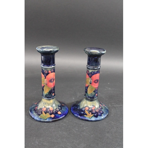 729 - PAIR OF MOORCROFT CANDLESTICKS - POMEGRANATE a pair of William Moorcroft candlesticks, in the Pomegr... 