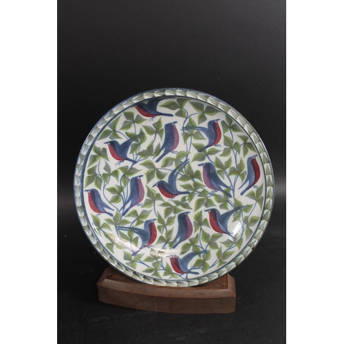 745 - LAURENCE MCGOWAN (B 1942) - STUDIO POTTERY DISH the stoneware dish brightly painted with birds among... 