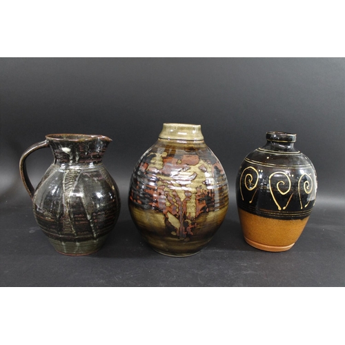 751 - ABUJA STUDIO POTTERY JUG with a tenmoku glaze and line decoration, seal mark to base of handle (diff... 