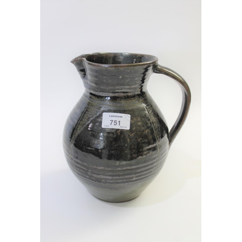 751 - ABUJA STUDIO POTTERY JUG with a tenmoku glaze and line decoration, seal mark to base of handle (diff... 