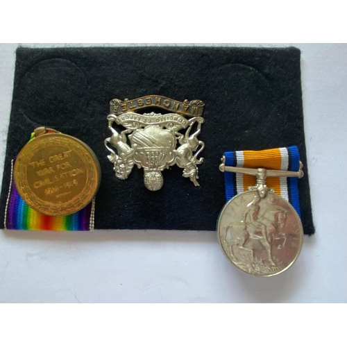 567 - A FIRST WORLD WAR CASUALTY PAIR AND CAP BADGE TO THE MANCHESTER REGIMENT. A Great War Pair comprisin... 