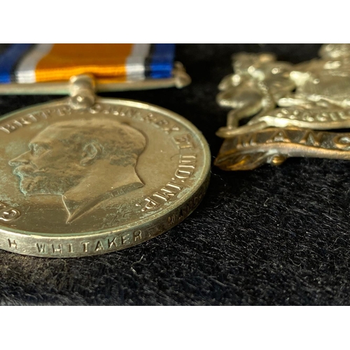 567 - A FIRST WORLD WAR CASUALTY PAIR AND CAP BADGE TO THE MANCHESTER REGIMENT. A Great War Pair comprisin... 