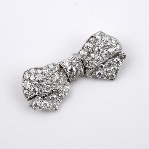 1178 - A DIAMOND BOW BROOCH. millegrain set with graduated circular-cut diamonds, 3.5cm wide.  **BP 22.5% i... 