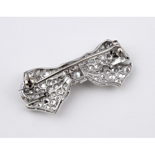 1178 - A DIAMOND BOW BROOCH. millegrain set with graduated circular-cut diamonds, 3.5cm wide.  **BP 22.5% i... 