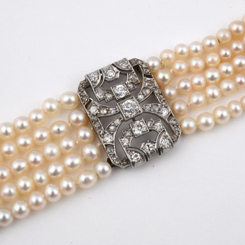 1180 - A CULTURED PEARL & DIAMOND BRACELET. formed as five rows of cultured pearls, with three rectangular-... 