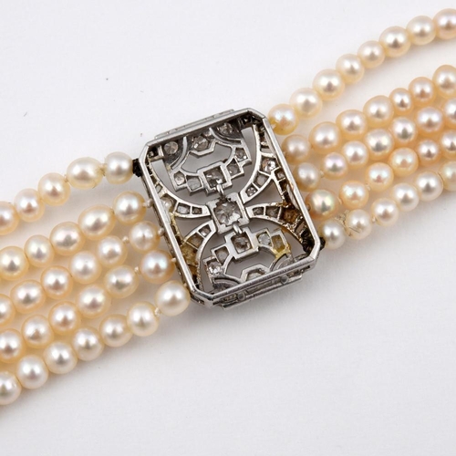 1180 - A CULTURED PEARL & DIAMOND BRACELET. formed as five rows of cultured pearls, with three rectangular-... 