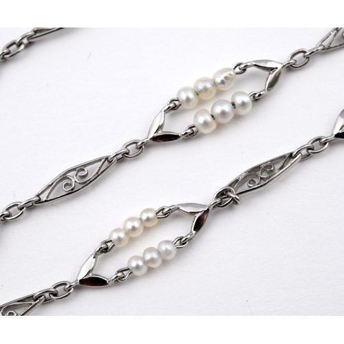 1183 - A PLATINUM AND PEARL SET LONG CHAIN NECKLACE. formed with alternate pearl set and openwork lozenge-s... 