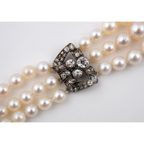 1185 - A DIAMOND AND CULTURED PEARL BRACELET. mounted with three rows of cultured pearls graduating from 6.... 