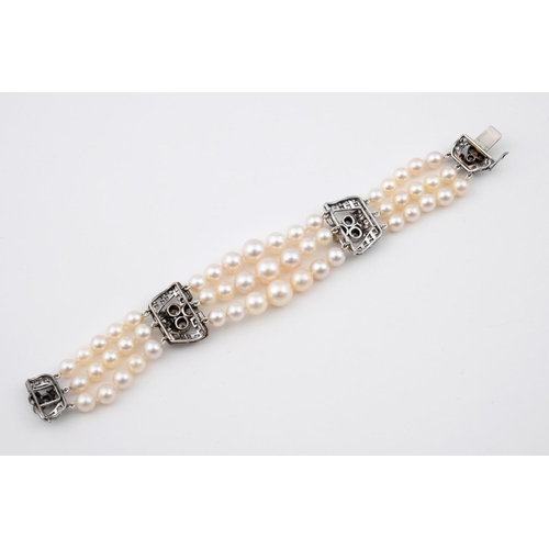 1185 - A DIAMOND AND CULTURED PEARL BRACELET. mounted with three rows of cultured pearls graduating from 6.... 