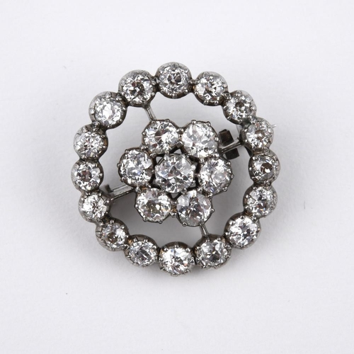 1193 - A DIAMOND TARGET BROOCH. mounted overall with round old-cut diamonds, in silver and backed in white ... 