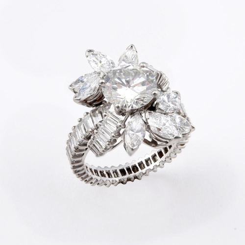 1196 - A DIAMOND FOLIATE CLUSTER COCKTAIL RING. centred with a brilliant-cut diamond weighing approximately... 