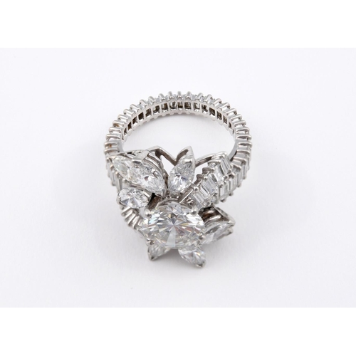 1196 - A DIAMOND FOLIATE CLUSTER COCKTAIL RING. centred with a brilliant-cut diamond weighing approximately... 