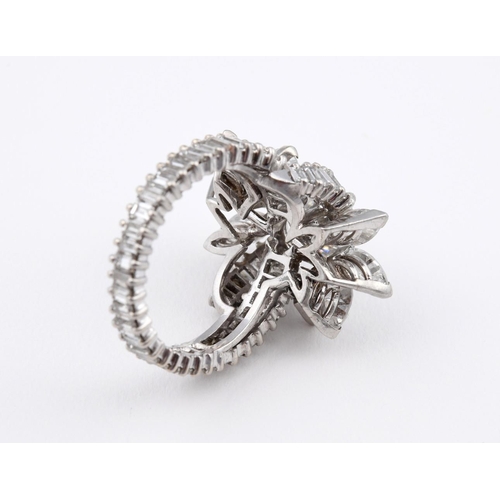 1196 - A DIAMOND FOLIATE CLUSTER COCKTAIL RING. centred with a brilliant-cut diamond weighing approximately... 