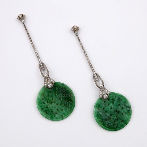 1198 - A PAIR OF ART DECO JADE & DIAMOND DROP EARRINGS. each set with a circular jade disc of foliate carve... 