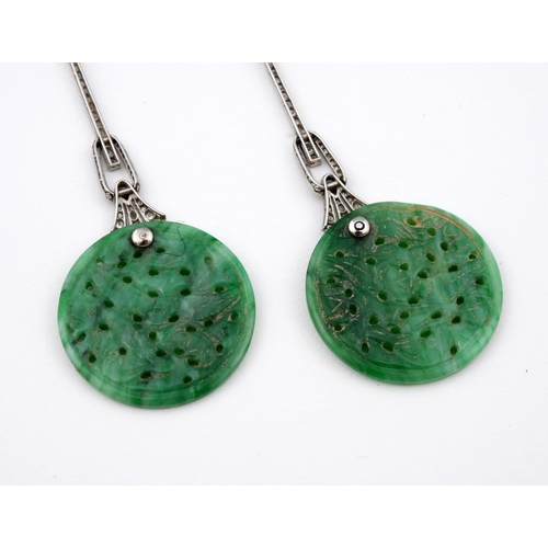 1198 - A PAIR OF ART DECO JADE & DIAMOND DROP EARRINGS. each set with a circular jade disc of foliate carve... 