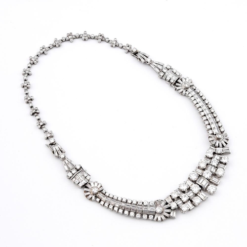 1201 - AN ART DECO DIAMOND NECKLACE. the centre section mounted with round brilliant-cut and baguette-cut d... 