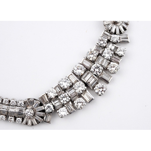 1201 - AN ART DECO DIAMOND NECKLACE. the centre section mounted with round brilliant-cut and baguette-cut d... 