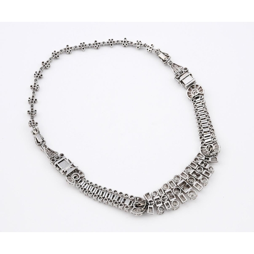 1201 - AN ART DECO DIAMOND NECKLACE. the centre section mounted with round brilliant-cut and baguette-cut d... 