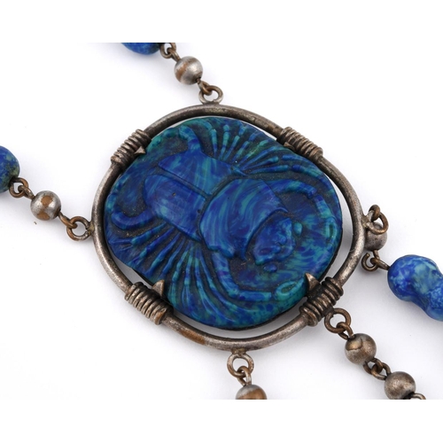 922 - A PATE DE VERRE NECKACE. depicting a scarab, mounted in metal, the pendant 4.5cm long.  **BP 22.5% i... 