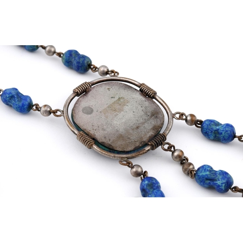 922 - A PATE DE VERRE NECKACE. depicting a scarab, mounted in metal, the pendant 4.5cm long.  **BP 22.5% i... 