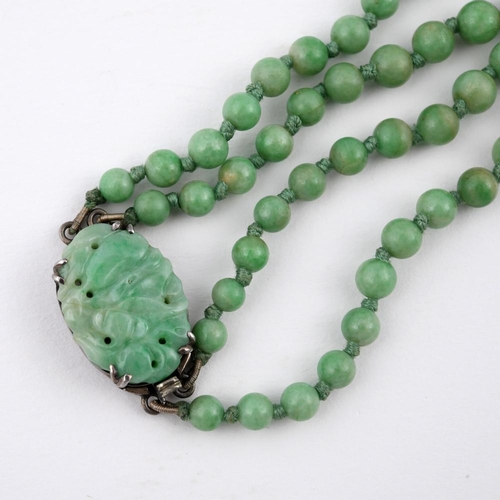 924 - A TWO ROW GRADUATED JADE BEAD NECKLACE. the jade beads graduate from approximately 4.1 to 9.8mm to a... 