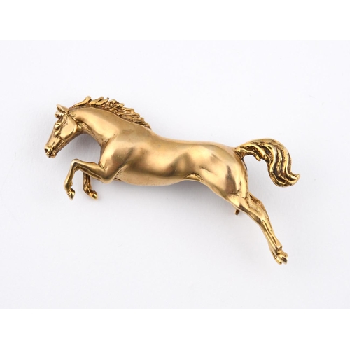 937 - A 9CT GOLD HORSE BROOCH. designed as a leaping horse, 5cm long, 12.9 grams, together with a 9ct gold... 