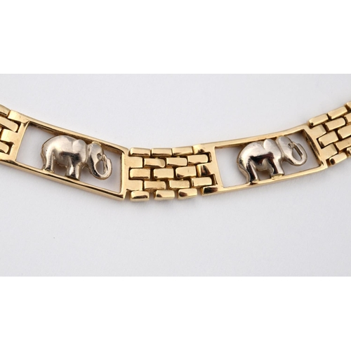 939 - A 14CT TWO COLOUR GOLD ELEPHANT COLLAR NECKLACE. formed alternately with standing elephants and bric... 