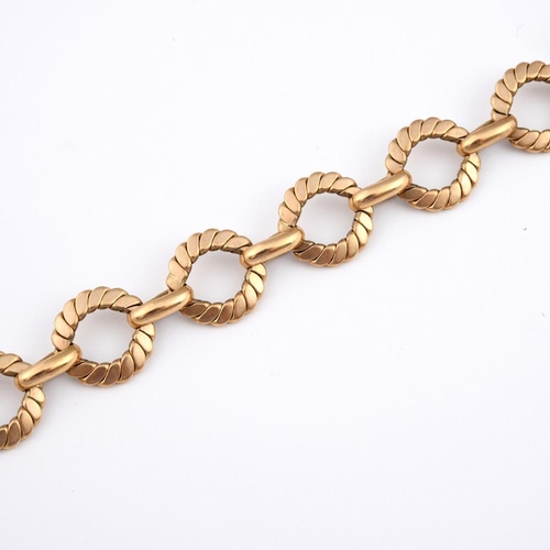 943 - A GOLD BRACELET. formed with circular engraved links, 22cm long, 32.7 grams.  **BP 22.5% inc VAT + L... 