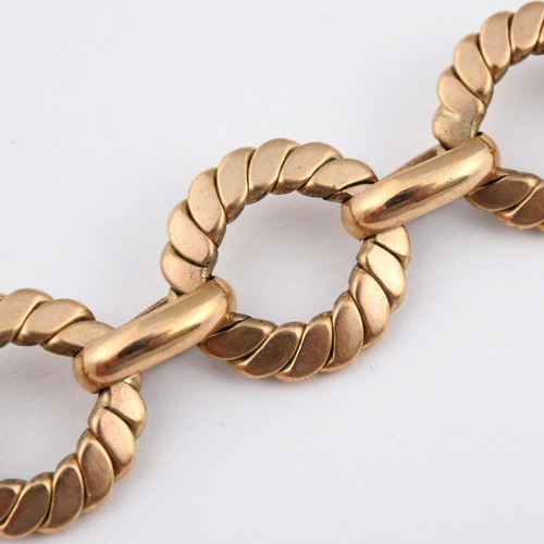 943 - A GOLD BRACELET. formed with circular engraved links, 22cm long, 32.7 grams.  **BP 22.5% inc VAT + L... 