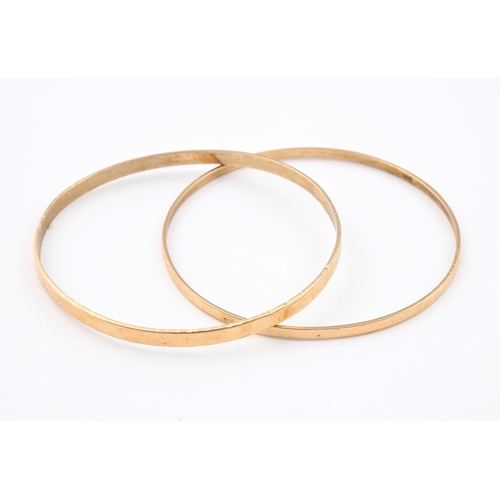 944 - TWO 14CT GOLD BANGLES. each of plain form, internal measurements approximately 6.5cm, 22 grams.  **B... 