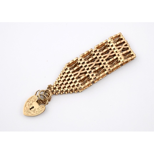 954 - A 9CT GOLD WIDE FANCY LINK BRACELET. with foliate engraved padlock clasp, 17cm long, 30.7 grams.  **... 