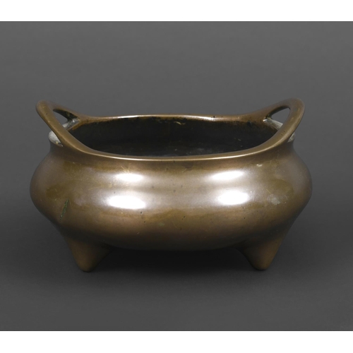 900 - CHINESE BRONZE CENSOR. Probably 18th century, the bronze censor with raised loop handles and support... 