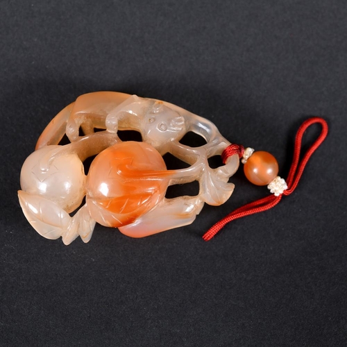 902 - CHINESE CARVED AGATE PENDANT. A 19thc agate pendant, carved with an animal figure possibly a Fox, an... 