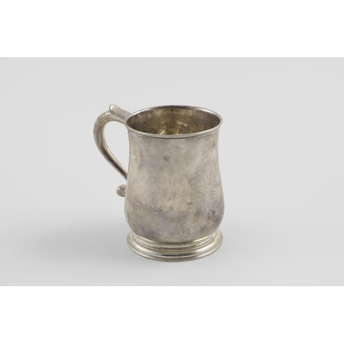 116 - A GEORGE II BALUSTER MUG. with a scroll handle and spreading circular foot, crested, London 1731 (ma... 