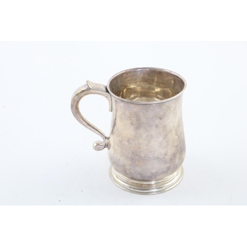 116 - A GEORGE II BALUSTER MUG. with a scroll handle and spreading circular foot, crested, London 1731 (ma... 