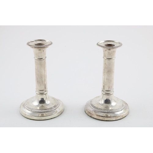 127 - A PAIR OF GEORGE III CANDLESTICKS. with detachable nozzles and gadrooned borders (loaded bases), by ... 