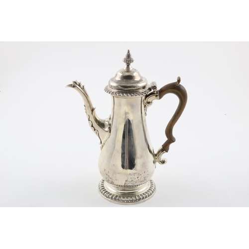 136 - A GEORGE III COFFEE POT. of baluster form, with a domed cover, domed foot, gadrooned borders and a l... 